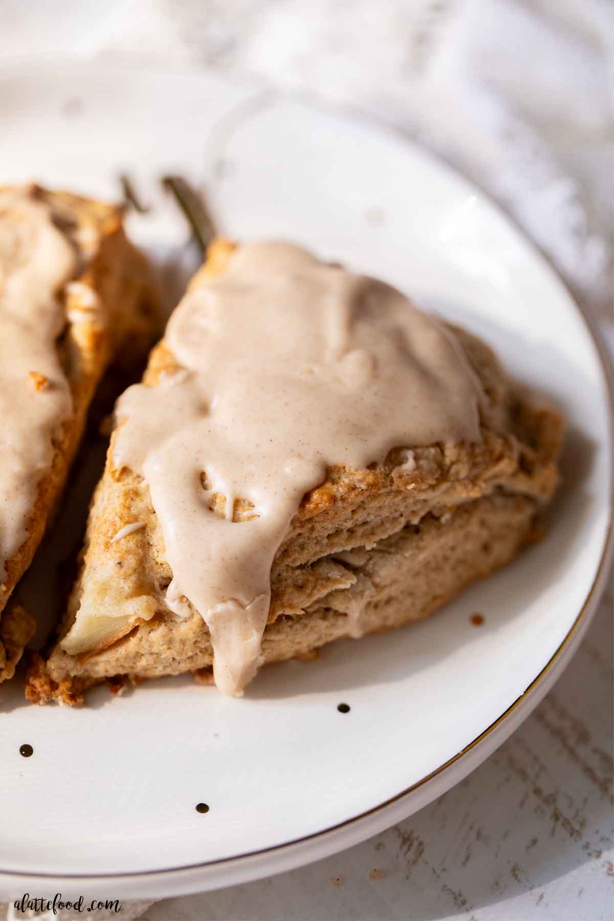 vanilla glazed pear scones baked on a white plate.